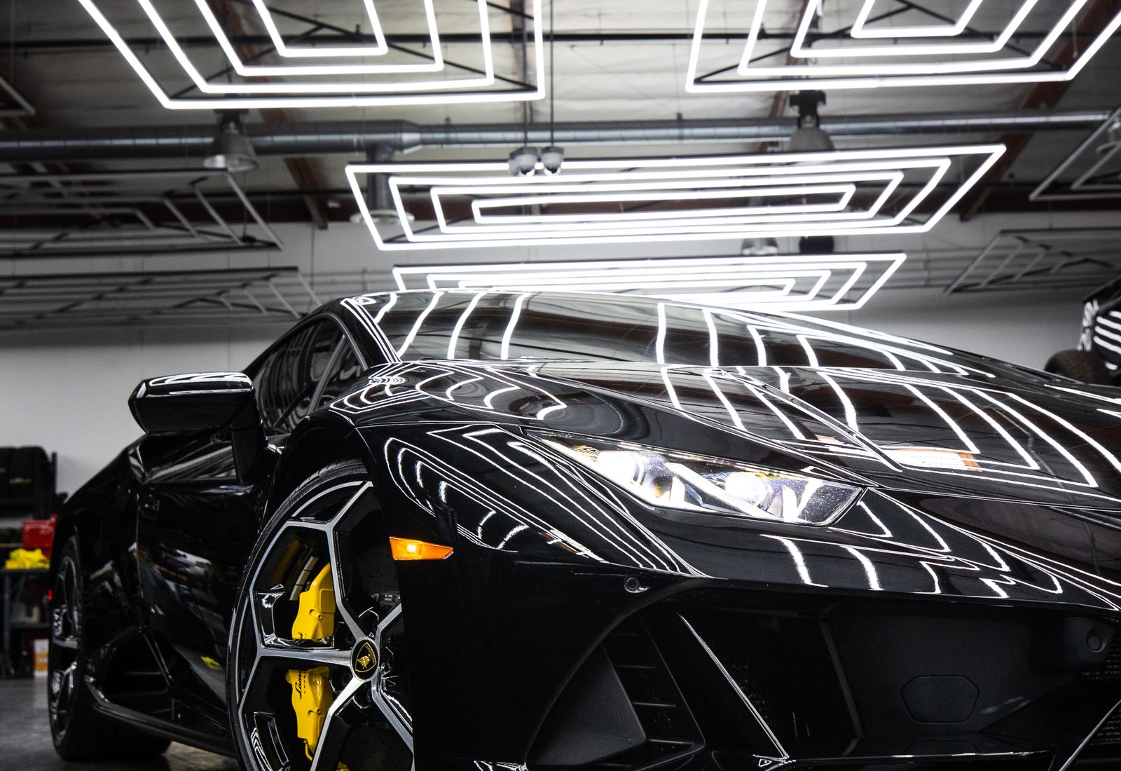 Black performance car in a modern automotive studio